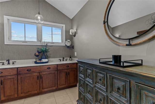 full bathroom with lofted ceiling, tile patterned floors, a sink, and double vanity