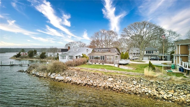 rear view of property with a water view