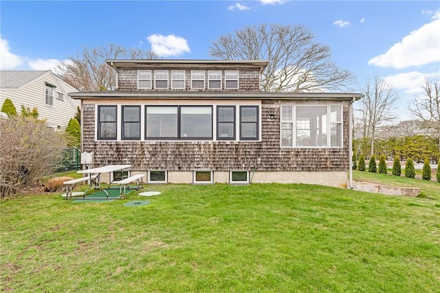 rear view of house featuring a yard
