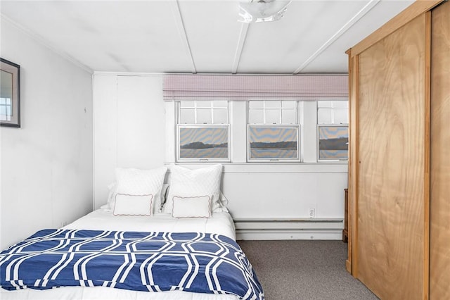 carpeted bedroom with a baseboard radiator