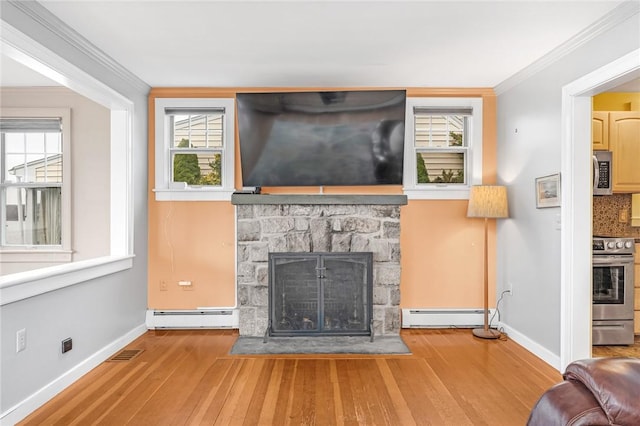 living area featuring a stone fireplace, visible vents, a baseboard heating unit, a baseboard radiator, and hardwood / wood-style flooring