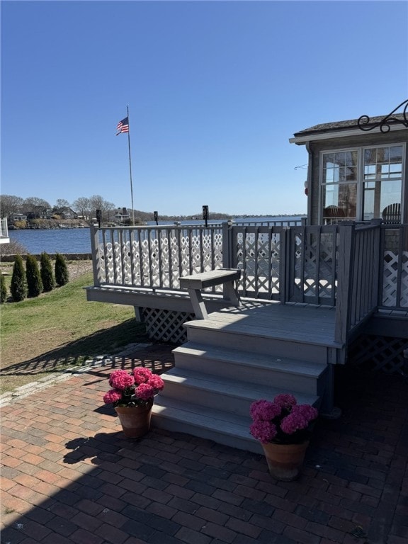 exterior space with a deck with water view