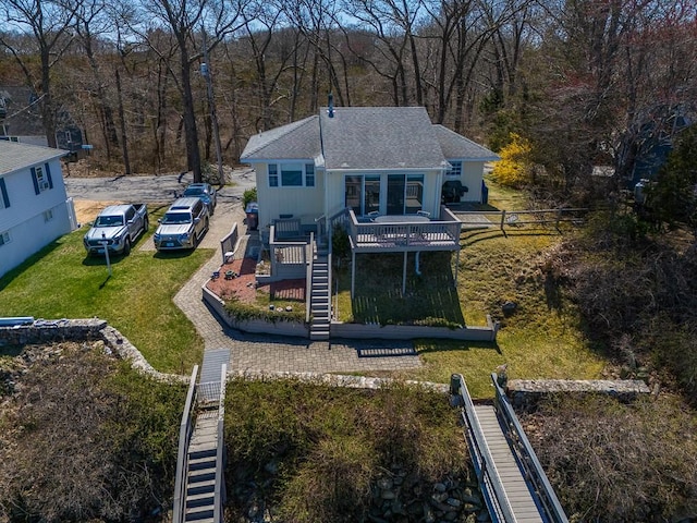 drone / aerial view with a wooded view