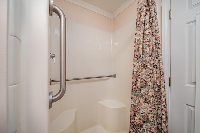 bathroom featuring crown molding and a shower with shower curtain