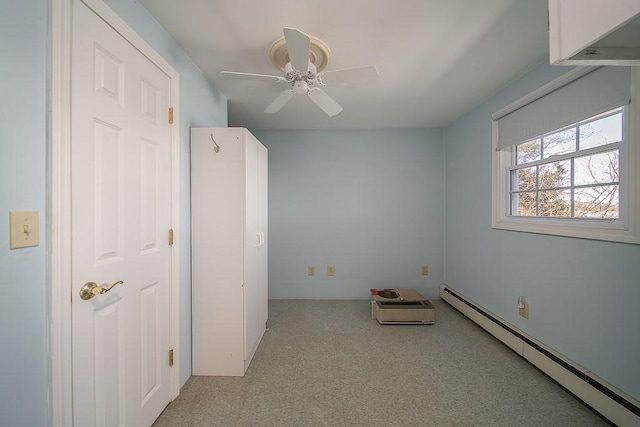 unfurnished room with a baseboard heating unit, light carpet, and ceiling fan