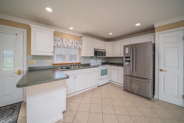 kitchen with stainless steel appliances, a sink, dark countertops, ornamental molding, and light tile patterned floors