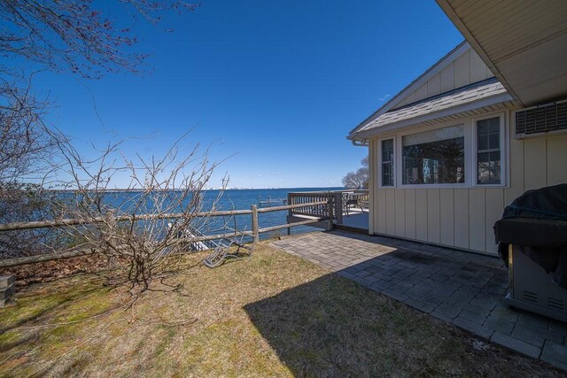 view of yard featuring a patio area and a water view