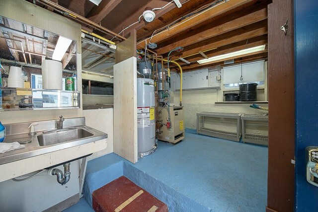 unfinished basement with electric water heater and a sink