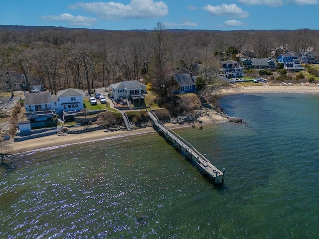 birds eye view of property featuring a wooded view, a residential view, and a water view