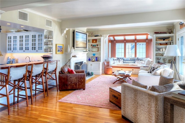 2 Harbor View Dr, Newport, RI 02840 - living area with wood finished floors, visible vents, and crown molding