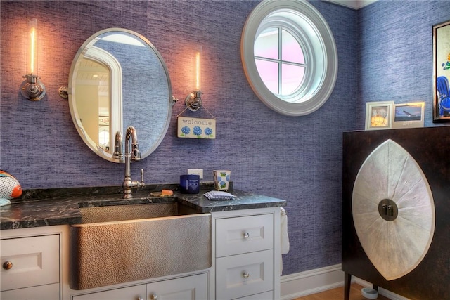 2 Harbor View Dr, Newport, RI 02840 - bathroom featuring baseboards, wood finished floors, and a sink