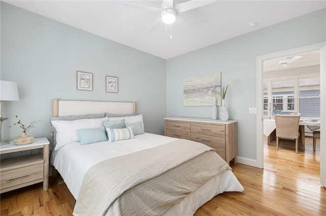 bedroom with baseboards, ceiling fan, and light wood finished floors