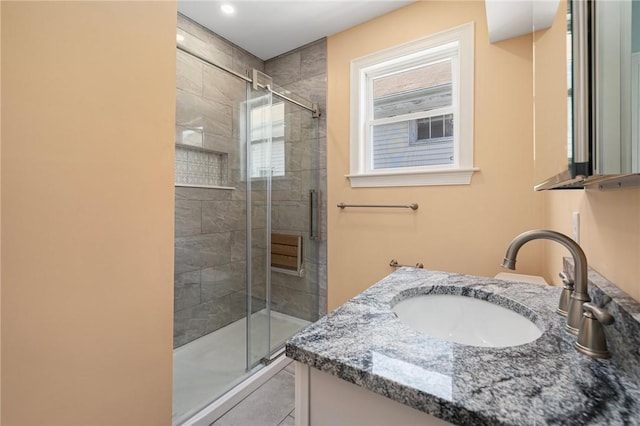 full bathroom featuring vanity, tile patterned floors, and a stall shower
