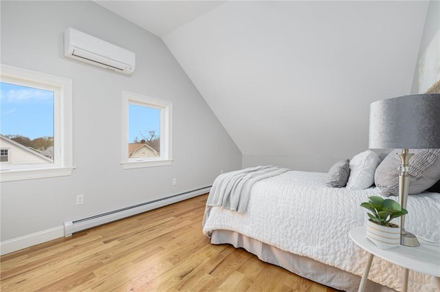 bedroom with a wall unit AC, light wood-type flooring, baseboards, a baseboard radiator, and lofted ceiling