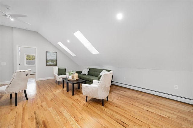 living area featuring ceiling fan, baseboards, a baseboard radiator, lofted ceiling with skylight, and light wood-style floors