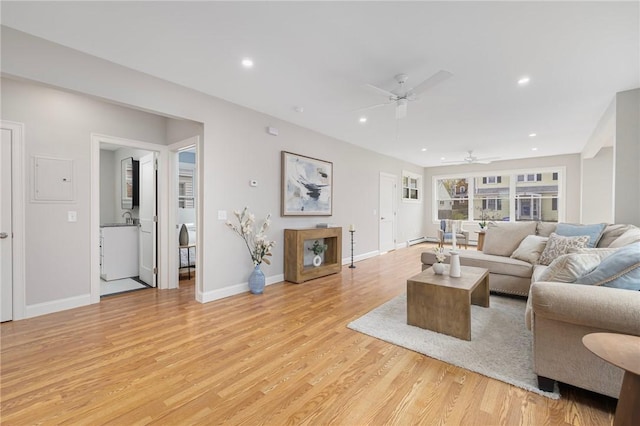 living room with recessed lighting, ceiling fan, baseboards, and light wood-style floors