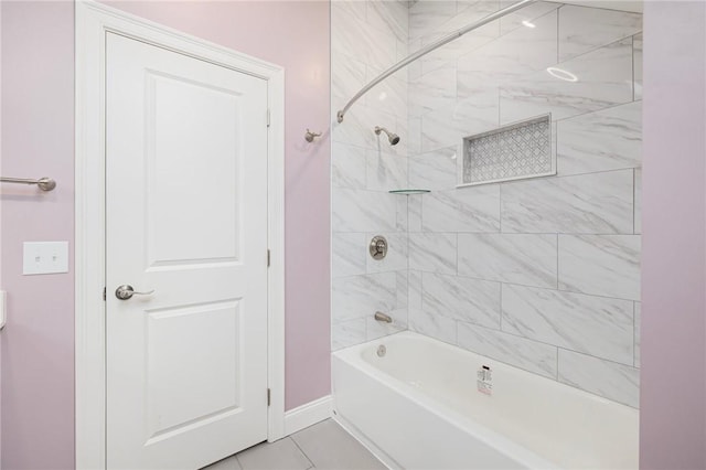 bathroom with baseboards, tile patterned flooring, and bathtub / shower combination