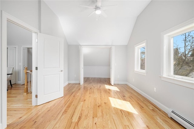 bonus room featuring a ceiling fan, vaulted ceiling, light wood-type flooring, baseboards, and a baseboard radiator
