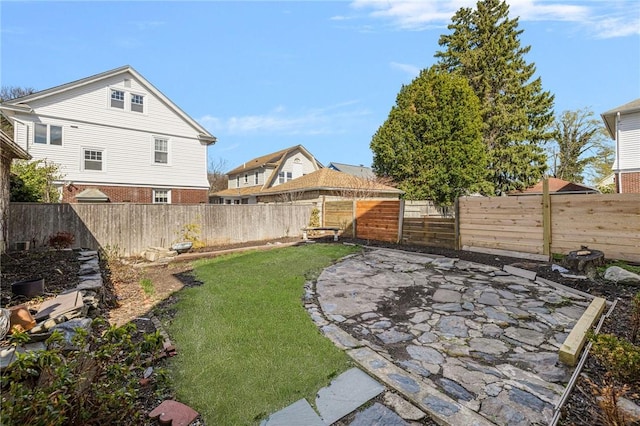 view of yard with a fenced backyard and a patio
