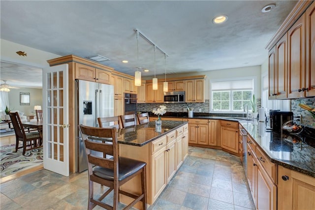 30 Rock Ridge Rd, Westerly, RI 02891 - kitchen with appliances with stainless steel finishes, a breakfast bar, a sink, backsplash, and a kitchen island