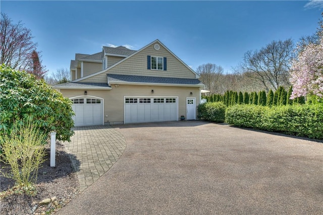 30 Rock Ridge Rd, Westerly, RI 02891 - view of home's exterior featuring an attached garage, a shingled roof, and aphalt driveway