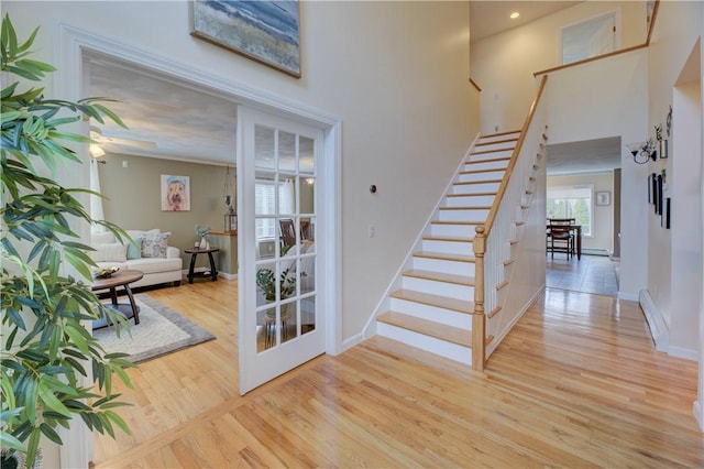 30 Rock Ridge Rd, Westerly, RI 02891 - stairs featuring baseboards, a towering ceiling, and wood finished floors