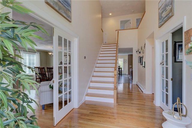 30 Rock Ridge Rd, Westerly, RI 02891 - entryway featuring a towering ceiling, baseboards, stairway, and light wood-type flooring