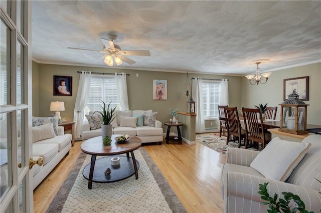 30 Rock Ridge Rd, Westerly, RI 02891 - living room featuring plenty of natural light, ornamental molding, ceiling fan with notable chandelier, and light wood-type flooring