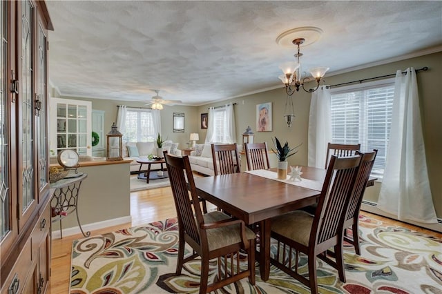 30 Rock Ridge Rd, Westerly, RI 02891 - dining room with ornamental molding, light wood finished floors, and a textured ceiling