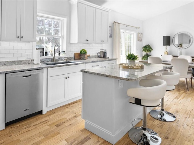 120 S Rd, East Greenwich, RI 02818 - kitchen with light wood finished floors, dishwasher, a breakfast bar, and a sink