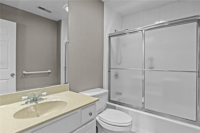 full bath featuring shower / bath combination with glass door, visible vents, toilet, and vanity