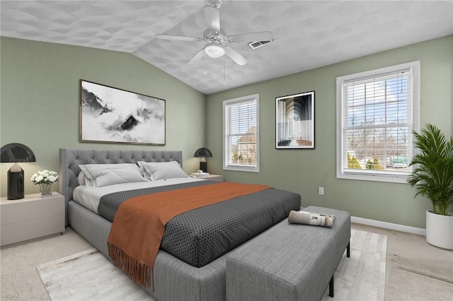 bedroom featuring vaulted ceiling, visible vents, a ceiling fan, light carpet, and baseboards