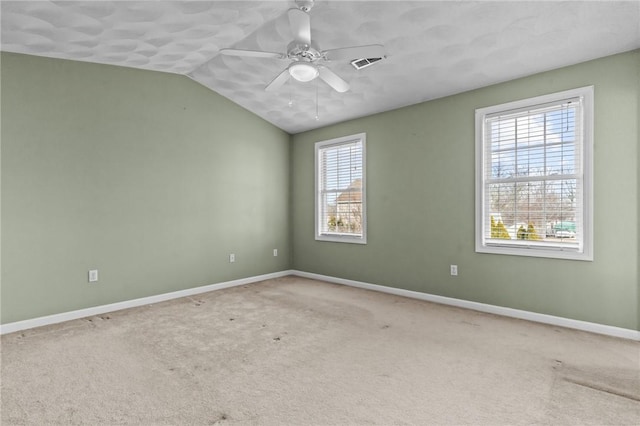 unfurnished room with baseboards, visible vents, carpet, and ceiling fan