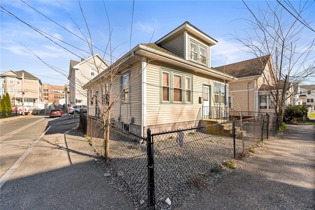 view of front of house featuring a residential view and a fenced front yard