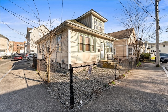 view of front of home featuring a residential view and a fenced front yard