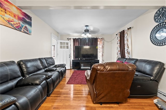 living room with light wood-style floors and a ceiling fan