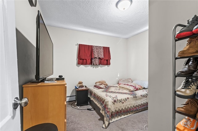 bedroom with carpet floors, a textured ceiling, and a baseboard radiator