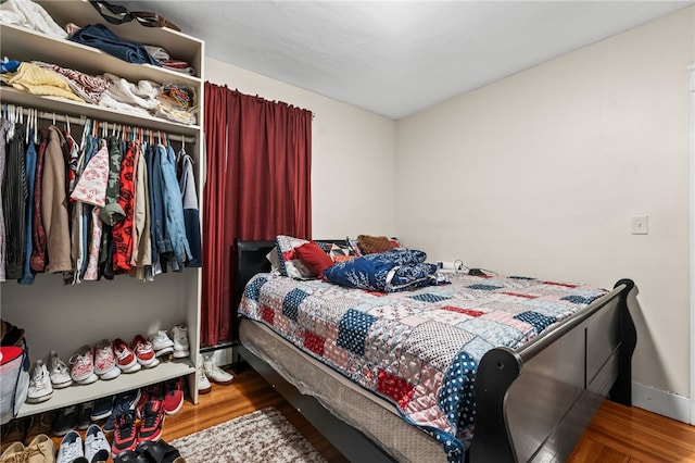 bedroom with wood finished floors and baseboards