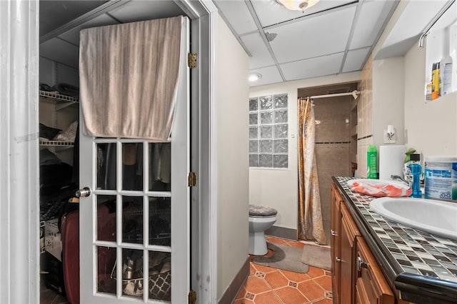 bathroom with tile patterned floors, toilet, vanity, and a shower with curtain