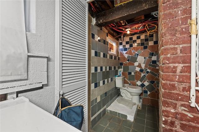 bathroom with toilet and tile patterned flooring
