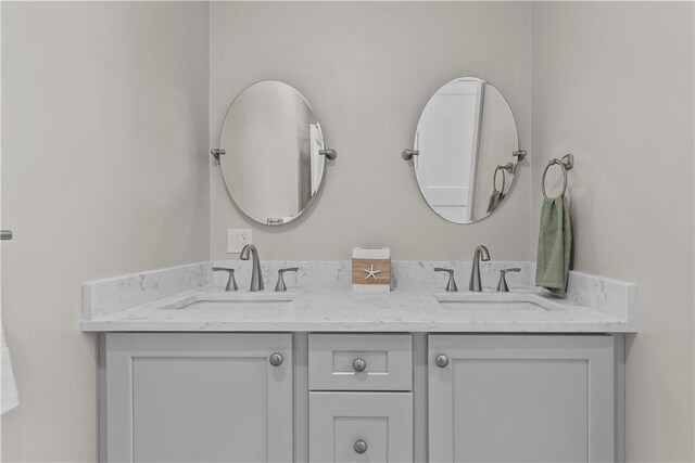 bathroom with a sink and double vanity