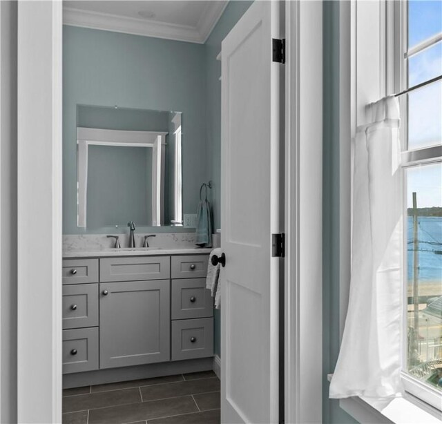 bathroom featuring vanity and ornamental molding