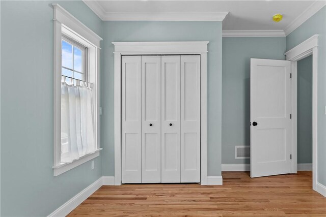 unfurnished bedroom with baseboards and light wood-style floors