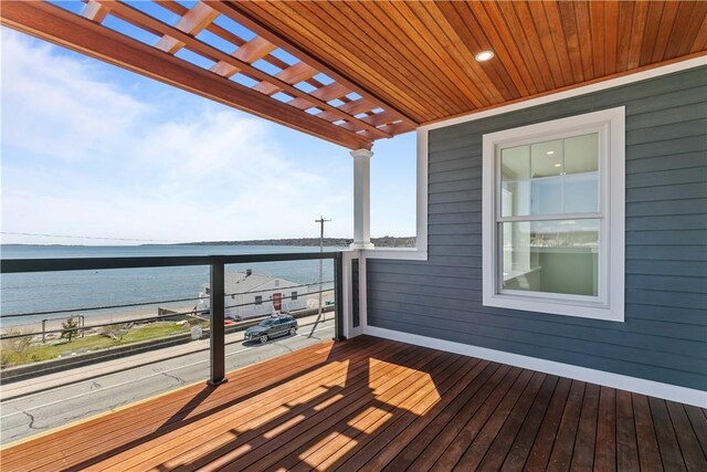 deck featuring a pergola and a water view