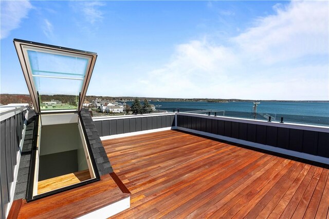 wooden deck featuring a water view