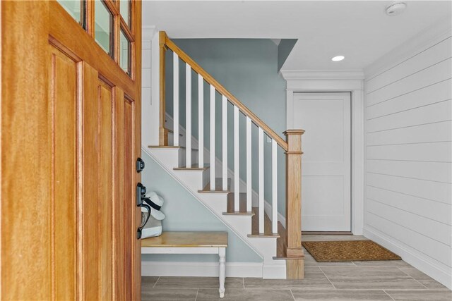 stairway featuring baseboards, recessed lighting, and ornamental molding