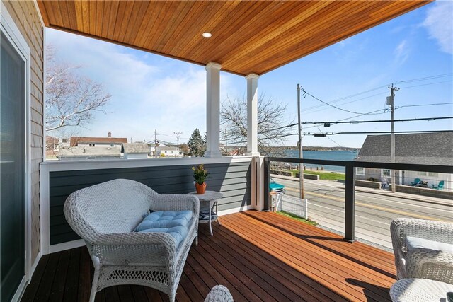 wooden terrace featuring a water view