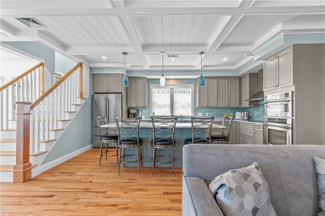 kitchen featuring light wood-style floors, gray cabinets, and stainless steel appliances