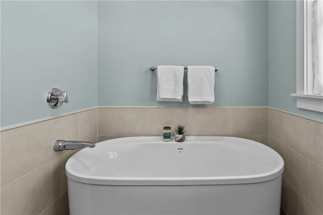 bathroom with a soaking tub