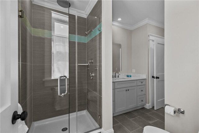 bathroom featuring a shower stall, ornamental molding, and tile patterned flooring
